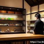 일본 술 전문점 소개 - A sophisticated Japanese liquor shop interior showcasing a wide variety of artisanal beverages inclu...